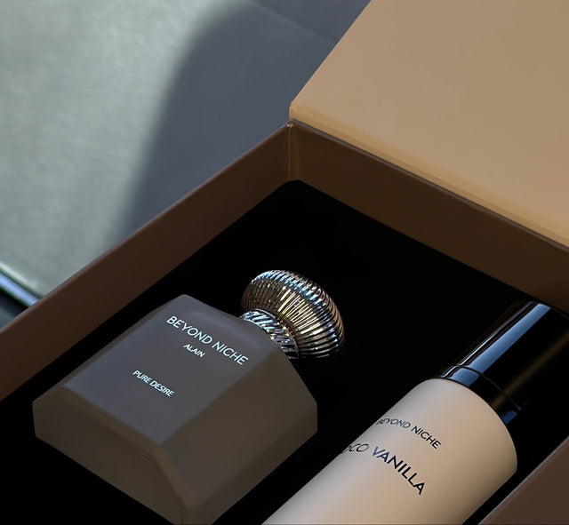 A frosted Beyond Niche bottle beside its cream box, silk draped behind